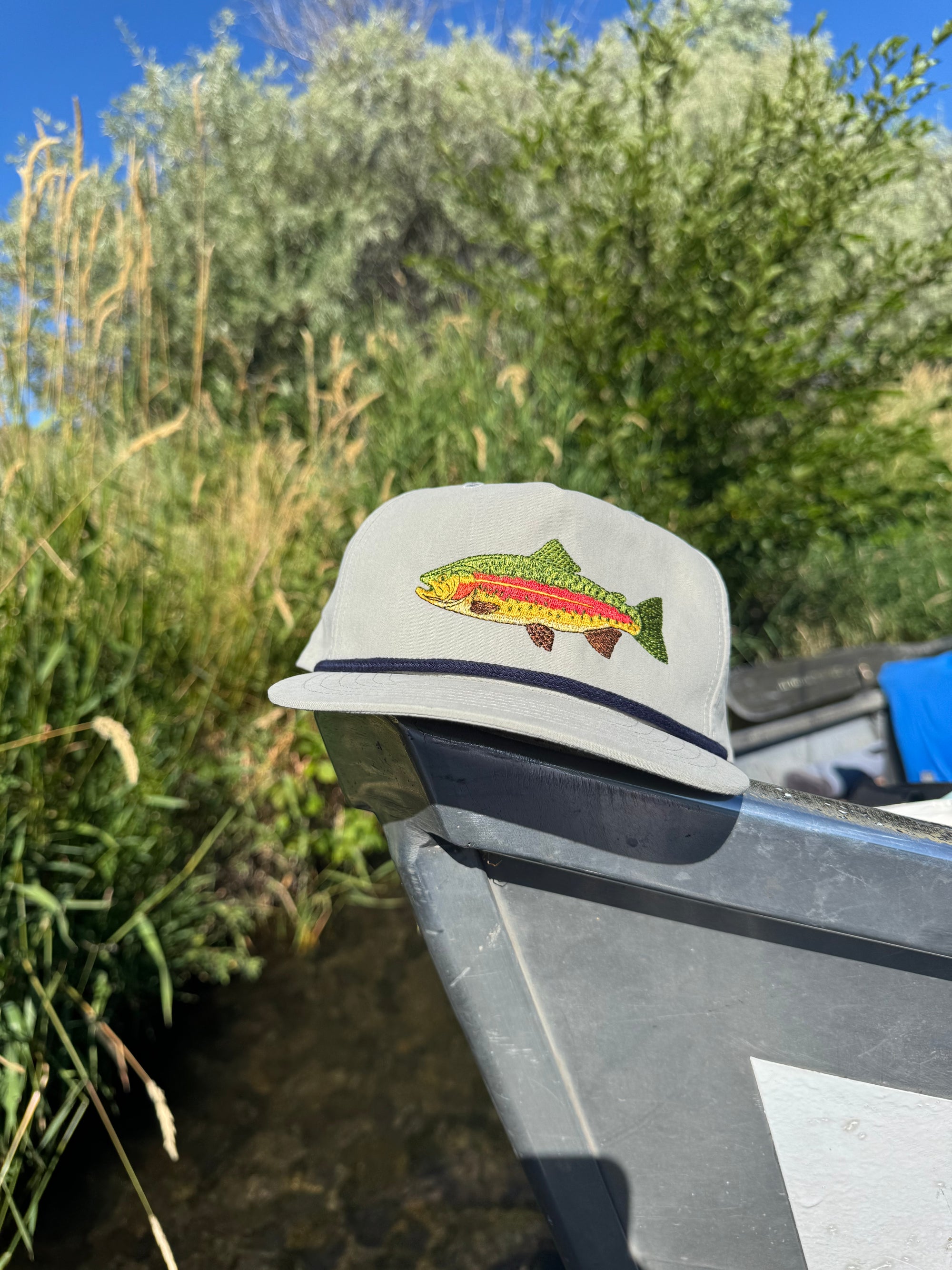 Rainbow trout hat - gray color - lifestyle shot on boat
