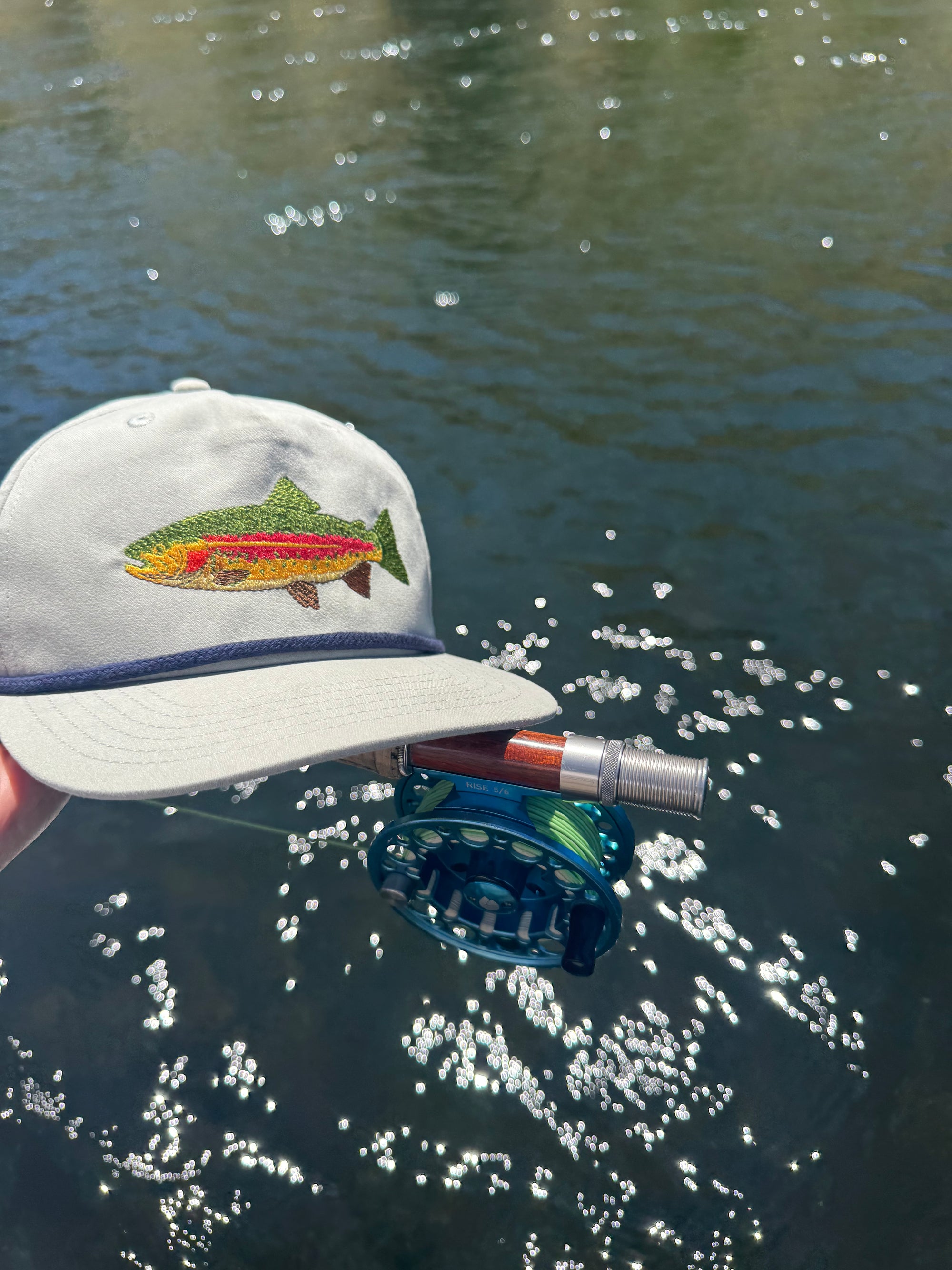 Rainbow trout hat - gray color - lifestyle shot with fly rod