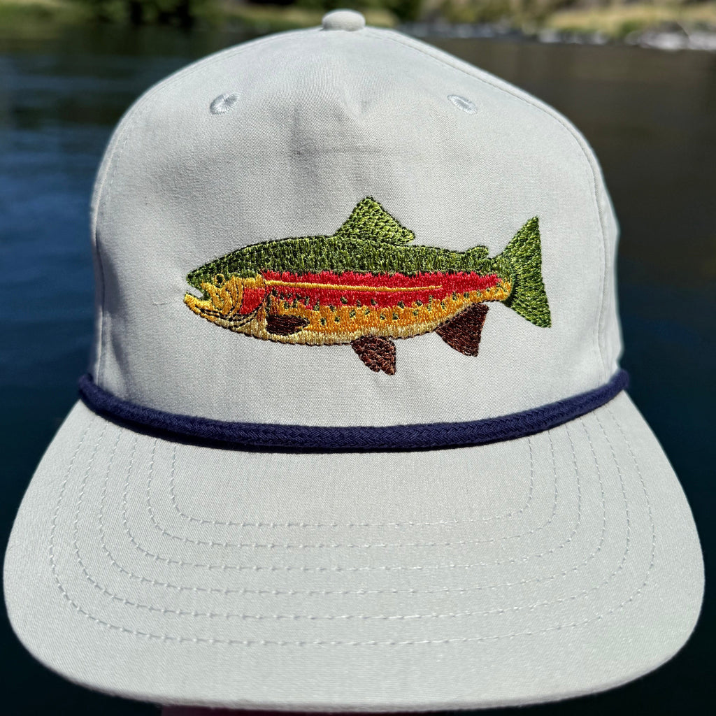 Rainbow trout hat against a mountainous background in Oregon on the Deschutes River