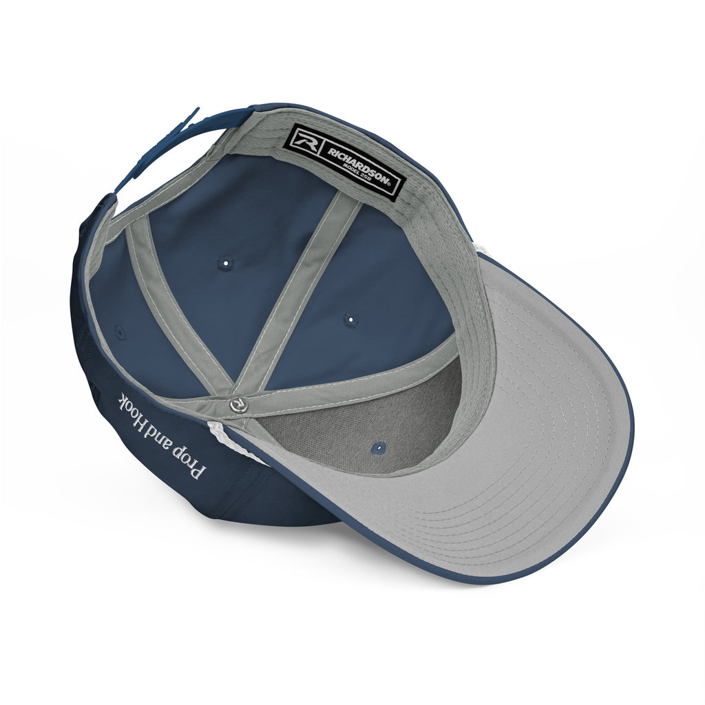 A blue and gray Feeding Frenzy Marlin Rope Hat by Prop and Hook is shown from above, revealing the interior structure, stitching, a headband with “Richardson” label, and “Pop and lock” printed on the inside edge.